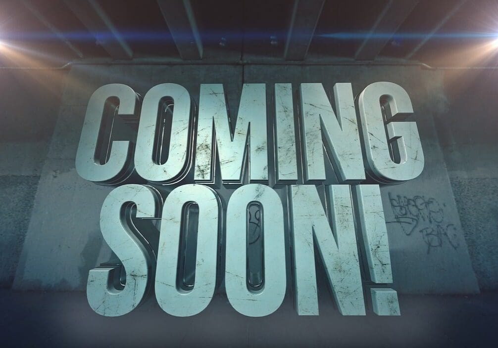 Large 3D text reading "COMING SOON!" with a background of a dimly lit wall and spotlights on the upper corners.